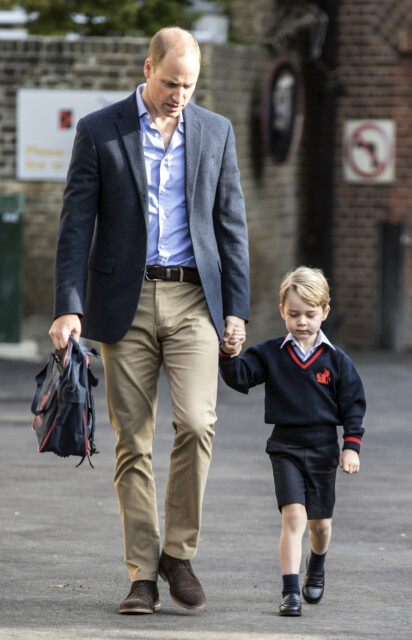 FILE - In this Thursday, Sept. 7, 2017 file photo, Britain's Prince William, left, holds Prince George's hand as he arrives for his first day of school at Thomas's school in Battersea, London. An alleged supporter of the Islamic State group accused of encouraging attacks on 4-year-old Prince George has changed his plea from innocent to guilty. The decision brought his trial in London to a dramatic halt on Thursday, May 31, 2018. (Richard Pohle/Pool Photo via AP, File)