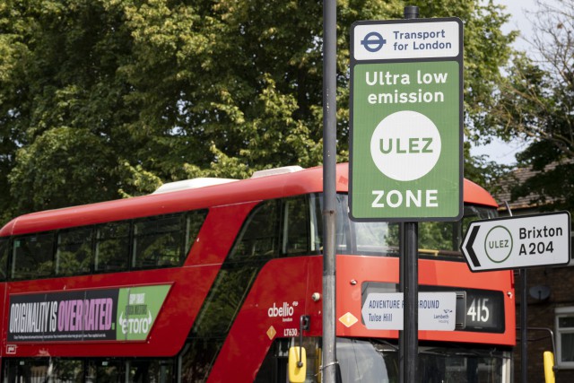 A local bus passes an ULEZ (Ultra Low Emission Zone) sign on the South Circular at Tulse Hill, on 21st July 2023, in London, England. Introduced by his Conservative predecessor Boris Johnson, London Mayor Sadiq Khan wants to expand the ULEZ area to a wider London to older vehicles such as polluting diesels and petrol cars, a controversial air quality policy to lower poisonous emissions that harms the health of 1 in 10 children. Drivers of non-exempt vehicles may enter the ULEZ after paying a £12.50 daily fee - or face a £160 penalty. (Photo by Richard Baker / In Pictures via Getty Images)